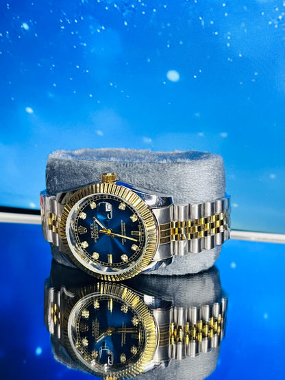 Luxury watch with blue face and gold accents on a reflective surface with a blue gradient background
